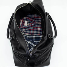 Load image into Gallery viewer, Open Franklin-Christoph Duffle Bag - Black Leather with plaid shirt inside, displayed on a clean white background.