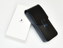 Load image into Gallery viewer, A black/indigo PPS24 Limited Production Leather by Franklin-Christoph rests on a white box with a small elegant logo.
