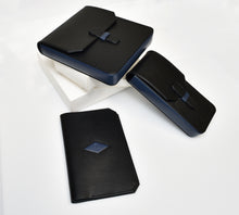 Load image into Gallery viewer, Three PPS24 Limited Production Leather Penvelopes by Franklin-Christoph on white boxes with blue accents.