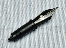 Load image into Gallery viewer, A Franklin-Christoph #6 Nib Unit with a metallic black steel tip and logo lies on a textured light grey background.