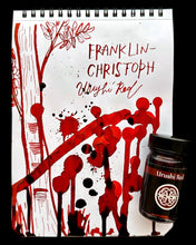 Load image into Gallery viewer, A notepad with Franklin-Christoph Bottled Ink swatches, beside glass bottles of this beautiful fountain pen ink.