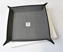 Load image into Gallery viewer, The Franklin-Christoph Valet Tray - Black Napa Suit Grey rests on a closed white box as a nightstand organizer.