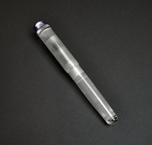 Load image into Gallery viewer, The Franklin-Christoph Model 20p Fountain Pen - Smoke &amp; Ice rests diagonally, sleek and empty, on a dark surface.