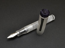 Load image into Gallery viewer, The Franklin-Christoph Model 20p Smoke &amp; Ice fountain pen with silver nib rests on a dark surface, cap set aside.