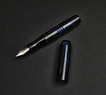 Load image into Gallery viewer, A pocket 45 OPS SE - Black Magic by Franklin-Christoph rests uncapped on a black textured surface—sleek and elegant.