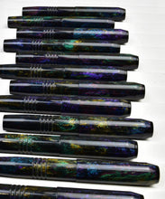 Load image into Gallery viewer, Ten iridescent Franklin-Christoph pens, including the pocket 45 OPS SE - Black Magic, line up on a white background.