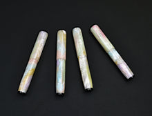 Load image into Gallery viewer, pocket 45 Opal acrylic fountain pen with base white in pearlescent colors. Four capped pens on a dark background. Onyx acrylic finials on each end.
