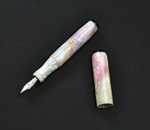 Load image into Gallery viewer, pocket 45 Opal acrylic fountain pen with base white in pearlescent colors. One uncapped pen on a dark background. Onyx acrylic finials on each end.