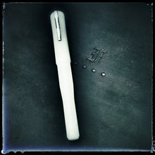 Load image into Gallery viewer, The Franklin-Christoph Model 02 Intrinsic Ghost fountain pen lies on a dark surface with an embossed F and three diamonds.