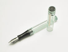 Load image into Gallery viewer, A Franklin-Christoph Model 03 Iterum Antique Glass &amp; Onyx pen lies uncapped, its silver nib echoing vintage elegance.