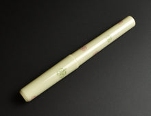 Load image into Gallery viewer, Franklin-Christoph Model 03 Modified FP: pistachio acrylic with olive red 4-leaf clovers on a sleek black background.