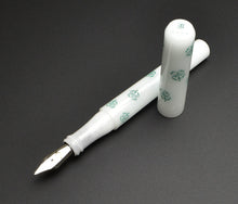 Load image into Gallery viewer, Franklin-Christoph Model 03M 4 Leaf in the Snow fountain pen, uncapped, on a dark surface.
