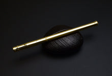 Load image into Gallery viewer, A Franklin-Christoph Solid Gold 18K Pencil Extender lies diagonally on a rare Italian holder with a black textured oval.