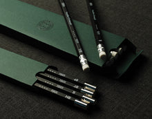 Load image into Gallery viewer, Four Franklin-Christoph 1901 Wood Pencils, in assorted grades, partly removed from a green box on a dark surface.