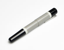 Load image into Gallery viewer, A Franklin-Christoph Model 19 Fountain Pen - GCB in gray and black lies diagonally on a white surface.