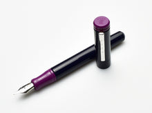 Load image into Gallery viewer, A Franklin-Christoph Model 20 Marietta Fountain Pen - Midnight Plum, uncapped, lies on a white background.