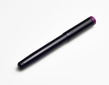 Load image into Gallery viewer, The Franklin-Christoph Model 20 Marietta in Midnight Plum rests diagonally on white, showcasing its elegant purple cap tip.