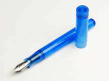 Load image into Gallery viewer, A Maya Blue Model 20 Marietta Fountain Pen by Franklin-Christoph with a #6 nib rests uncapped on a white background.