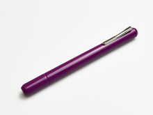 Load image into Gallery viewer, A Franklin-Christoph Model 25 Eclipse FP in Plum with a silver clip lies diagonally on a white background.