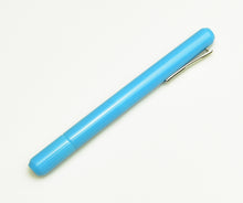 Load image into Gallery viewer, A Franklin-Christoph Model 25 Eclipse Fountain Pen - Sky Blue SE with a nib rests diagonally on a white background.