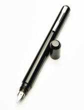 Load image into Gallery viewer, Franklin-Christoph Model 25 Eclipse Fountain Pen in Classic Black, cap off, nib facing down on white background.