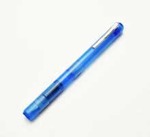 Load image into Gallery viewer, Franklin-Christoph Model 25 Eclipse Fountain Pen in Maya Blue with a downward nib rests diagonally on a white background.