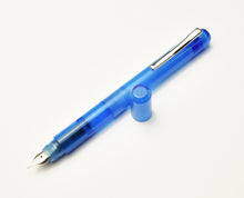 Load image into Gallery viewer, A Maya Blue Franklin-Christoph Model 25 Eclipse fountain pen with nib down, cap off, on a white surface.