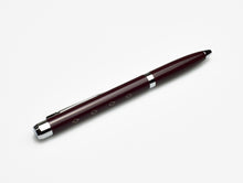 Load image into Gallery viewer, A Franklin-Christoph Model 28 Shortstock Ballpoint - Maroon rests diagonally on a white surface with diamond patterns.