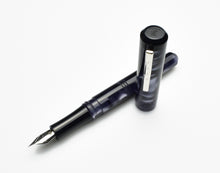 Load image into Gallery viewer, A Franklin-Christoph Model 31 Omnis Fountain Pen in Black Smoke, with its cap beside it on a white background.