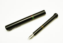 Load image into Gallery viewer, Franklin-Christoph Model 33 Abditus Black Cathedral fountain pen, silver nib/cap, red/yellow/green stripes on white.