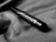 Load image into Gallery viewer, Franklin-Christoph Model 40 Panther Diamondtree LE FP fountain pen rests on a soft, textured fabric surface.