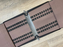 Load image into Gallery viewer, The Franklin-Christoph 40 Pen Case -Seconds-Black leather is shown opened, with a gray hinge, on a wood floor.