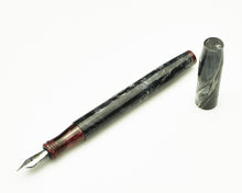 Load image into Gallery viewer, A Franklin-Christoph Model 45XL - Charcoal &amp; Creme w/ Red &amp; White uncapped, displaying its No. 5 nib on white.