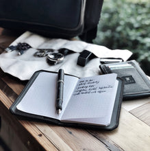 Load image into Gallery viewer, Franklin-Christoph 5.3 Pocket Notebook Refills with 64 pages on a wooden table beside a wallet and watches by the window.