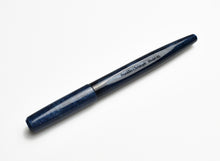 Load image into Gallery viewer, A Franklin-Christoph Model 65 Stabilis FP - Diamondcast Blue Orchid desk pen, capped, rests on a white background.
