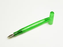 Load image into Gallery viewer, A Franklin-Christoph Model 65 Stabilis Kerry Green SE fountain pen with its cap off, placed beside it on white.