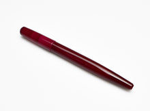 Load image into Gallery viewer, A closed Franklin-Christoph Model 65 Stabilis in Sweet Maroon rests diagonally on a plain white background.