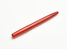Load image into Gallery viewer, A Franklin-Christoph Model 65 Stabilis Fountain Pen in Venetian Red with cap rests on a white background at an angle.