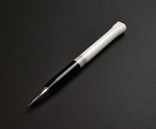 Load image into Gallery viewer, The Franklin-Christoph Model 90 Artium Pencil - Black White, sleek and grayscale, rests diagonally on a dark surface.