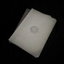 Load image into Gallery viewer, Two Greybooks by Franklin-Christoph, A5 size with Celtic knot design, on fountain pen paper, rest on a black surface.