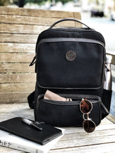 Load image into Gallery viewer, The Franklin-Christoph Fortis Backpack delivers stylish daily storage, pictured with essentials on a bench.