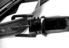 Load image into Gallery viewer, Black-and-white close-up of Franklin-Christoph CL1 Belt with leather accents and metal buckle on white surface.