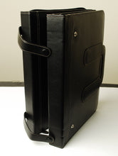 Load image into Gallery viewer, The Franklin-Christoph 80 Pen Case, a large black leather briefcase with two handles, sits upright on a white surface.