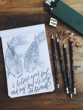 Load image into Gallery viewer, A sketchpad with koi fish art is surrounded by Franklin-Christoph 1901 Wood Pencils, a sharpener, and shavings.