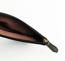 Load image into Gallery viewer, A close-up of the Franklin-Christoph Zippered Single Pen Pouch in black Napa leather with brown interior on white.