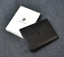 Load image into Gallery viewer, A Franklin-Christoph Card Wallet crafted from black grained napa leather is displayed open beside a white box bearing a logo on a dark grey fabric surface.