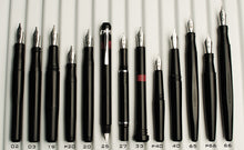 Load image into Gallery viewer, Fourteen Franklin-Christoph fountain pens shown vertically on white: 1 F-C Fountain Pen Comparison with silver nibs.