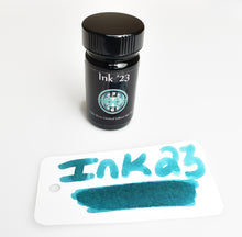 Load image into Gallery viewer, A Franklin-Christoph Ink ’23 1oz Bottle sits by a teal swatch tag, handwritten for the Philly Show.