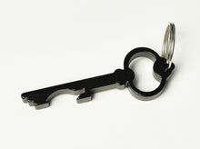 Load image into Gallery viewer, Franklin-Christoph Key Ring and Bottle Opener in black aluminum, key-shaped and lightweight, on a white surface.