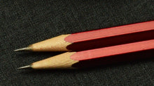 Load image into Gallery viewer, Two Franklin-Christoph 1901 Wood Pencils lie parallel on a dark textured surface.